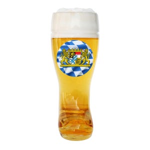 May include: A tall beer glass filled with golden beer and topped with a thick layer of white foam. A round sticker with the Bavarian coat of arms is affixed to the glass. The glass has a unique boot-shaped base.
