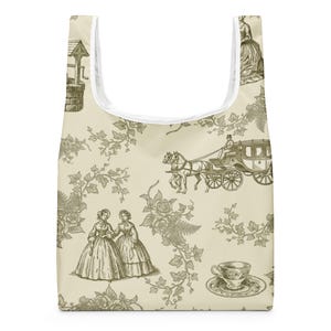 May include: Beige reusable shopping bag featuring a vintage toile pattern. The design includes illustrations of a horse-drawn carriage, women in dresses, a well, and floral elements. The bag has a white interior and a top opening.