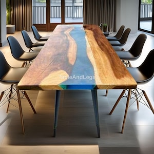 May include: A large wooden dining table with a blue resin river design. The table has a natural wood grain finish with a blue and green epoxy river. The table is supported by gray metal legs. The table is surrounded by black chairs.