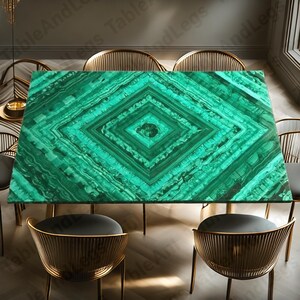 May include: A rectangular dining table with a vibrant green malachite top featuring a diamond pattern. The table is surrounded by gold-colored chairs with black seats, creating an elegant dining set.