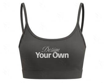 Może przedstawiać: Ciemnoszary biustonosz sportowy z cienkimi ramiączkami i okrągłym dekoltem. Z przodu odzieży znajduje się napis "Design Your Own" wydrukowany białą czcionką bezszeryfową, przy czym słowo "Design" jest zapisane kursywą.