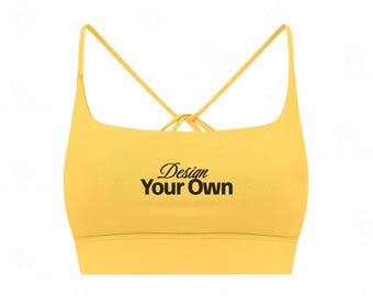 Może przedstawiać: Żółty biustonosz sportowy z krzyżowym tyłem. Tekst "Design Your Own" jest wydrukowany na czarno z przodu. Biustonosz ma cienkie ramiączka i okrągły dekolt.