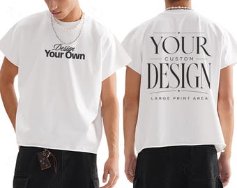 Może przedstawiać: Biała koszulka z napisem "Design Your Own" z przodu i "Your Custom Design" z tyłu. Koszulka ma luźny krój i krótkie rękawy. Z tyłu koszulki znajduje się również napis "Large Print Area".