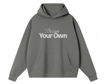 Może przedstawiać: Ciemnoszara bluza z kapturem i długimi rękawami, posiadająca przednią kieszeń typu kangur oraz biały nadruk z napisem "Design Your Own" na klatce piersiowej. Odzież posiada kaptur oraz ściągacze przy rękawach i na dolnej krawędzi bluzy.
