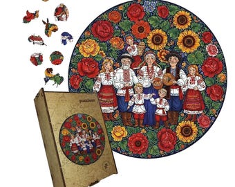 May include: A wooden jigsaw puzzle with a folk art design featuring a family in traditional clothing surrounded by flowers. The puzzle is round, with a matching box. Several puzzle pieces are scattered around the box.