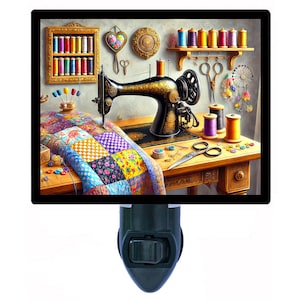 May include: A night light featuring a detailed illustration of a sewing room. The image shows a vintage sewing machine, a colorful quilt in progress, spools of thread, and sewing tools. The scene is set on a wooden table.