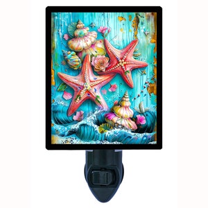 May include: A night light featuring a colorful illustration of starfish and seashells on a blue and green wooden background.