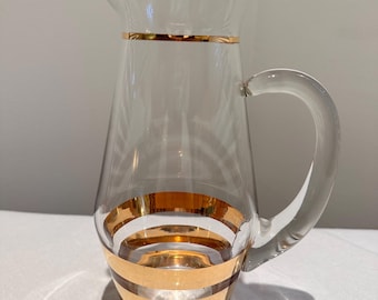 A mid-century modern glass pitcher with gold banding. 1950s