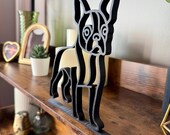 Close-up view of the Boston Terrier sculpture highlighting its clean single line design and matte black finish. Perfect as bookshelf decor, dog lover keepsake, or unique pet memorial.