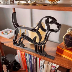 Three-quarter angle of a large Beagle line art sculpture on a wooden bookshelf with vintage decor, glassware, and colorful cookbooks below — oversized 3D printed minimalist beagle home decor and a heartfelt beagle gift idea for shelves, mantels, and dog lover homes.