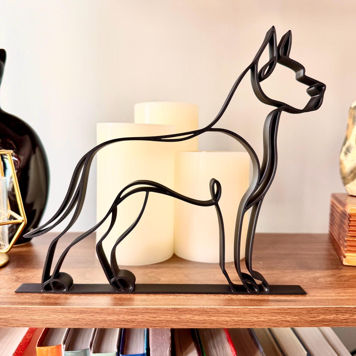Matte black Great Dane continuous line sculpture on wooden shelf with warm candles, unique gift for Great Dane parents home decor