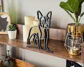 Boston Terrier line art sculpture styled with modern shelf decor including candles and plants. A sleek and lightweight dog figure for contemporary home accents and Boston Terrier owners.