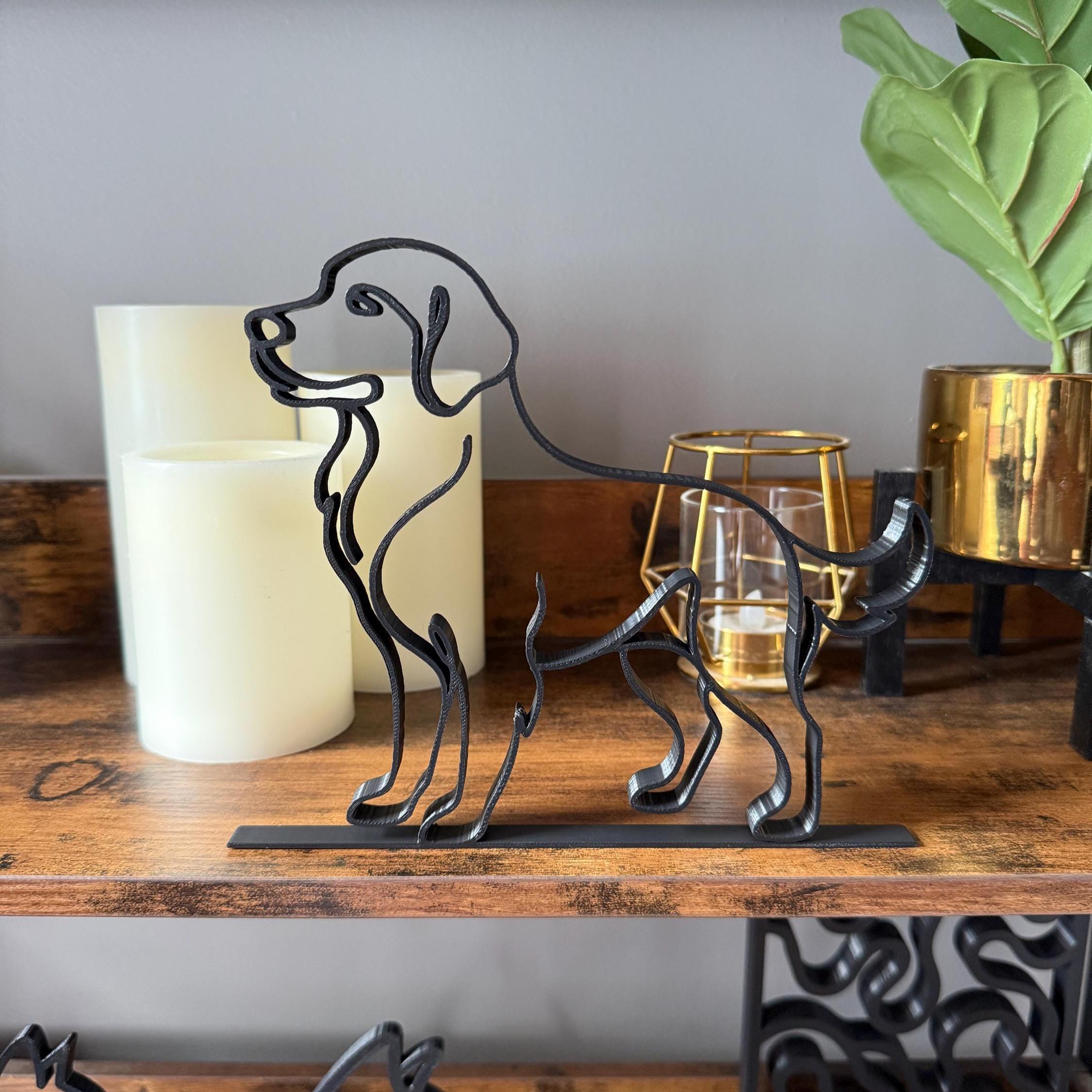 Golden Retriever line art sculpture in matte black on bookshelf