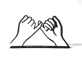 Minimalist black 3D printed pinky promise line art sculpture displayed on a clean white background. The design features two hands linking pinky fingers in a symbolic gesture of trust, loyalty, and love. Ideal as a friendship gift, romantic anniversary decor, or meaningful shelf art for modern and boho-style homes. This mockup showcases the sculpture’s sleek lines, clean base, and thoughtful handmade design, perfect for gifting or home styling.