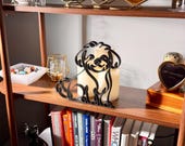 Styled lifestyle scene of a Maltipoo line art sculpture on a wooden display shelf with candles, glassware, vintage books, and decorative accents — modern minimalist Maltipoo home decor, doodle dog art, and a heartfelt Maltipoo gift idea for shelves, mantels, and dog lover homes.