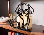Maltipoo line art sculpture showing detailed curly coat texture, posed on a wooden bookshelf with a soft glowing candle and vintage books below — minimalist 3D printed Maltipoo home decor and a thoughtful Maltipoo gift for dog moms, dog dads, and doodle lovers.
