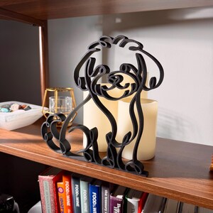Maltipoo line art sculpture showing detailed curly coat texture, posed on a wooden bookshelf with a soft glowing candle and vintage books below — minimalist 3D printed Maltipoo home decor and a thoughtful Maltipoo gift for dog moms, dog dads, and doodle lovers.
