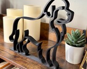 Forward angled view of minimalist Newfoundland Dog line art sculpture in matte black. Handmade 3D printed decor designed for dog owners, pet lovers, and modern interiors. Lightweight yet durable with crisp edges, making it ideal for display on shelves, mantels, or desks. A unique piece of contemporary home decor that celebrates the loyal and gentle Newfoundland breed while blending seamlessly with various design styles.