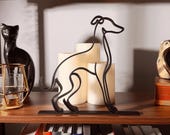 Minimalist Italian Greyhound sculpture on a bookshelf with candles, books, and decorative accents, showcasing elegant black line art perfect for modern dog lover décor.