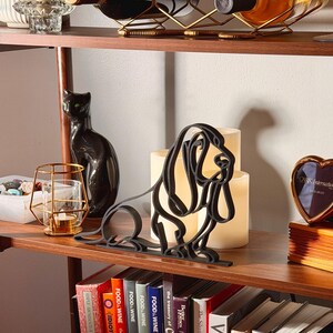 Close-up of the matte black PLA texture and clean line art details on the Basset Hound sculpture.