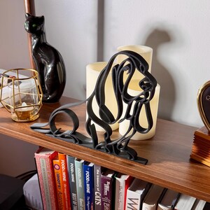 Front view of Basset Hound continuous line art sculpture in matte black PLA.