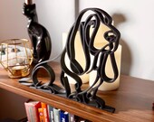 Matte black 3D printed Basset Hound line art sculpture shown as minimalist dog decor.