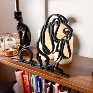 Matte black 3D printed Basset Hound line art sculpture shown as minimalist dog decor.