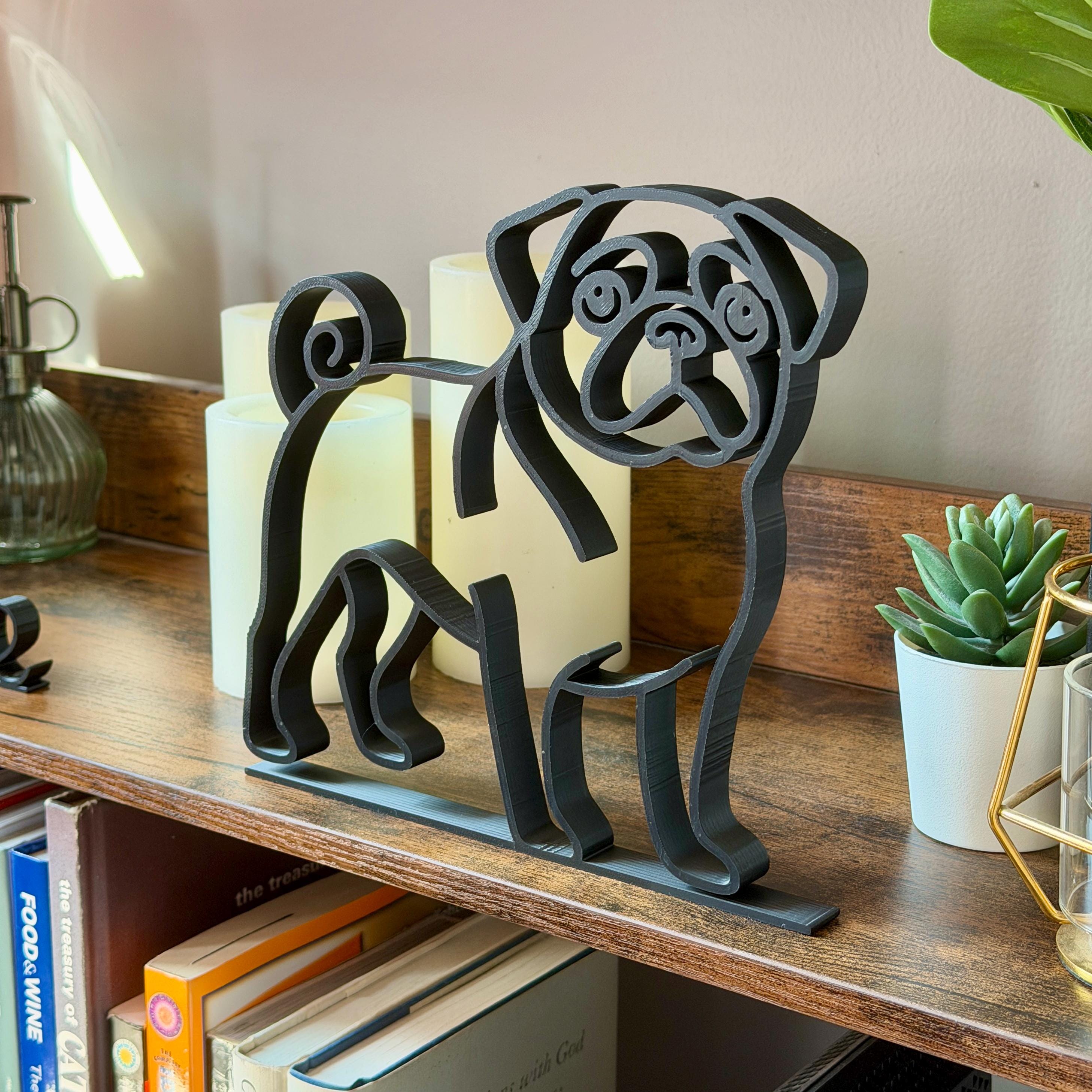 Matte black French Bulldog line art sculpture on modern shelf as non-tacky dog decor