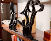 Close-up of a large matte black Beagle line art sculpture highlighting the breed's long floppy ears, sweet hound face, and continuous-line silhouette, styled on a wooden shelf with bookshelf and candles — oversized 3D printed beagle decor and a thoughtful beagle gift for dog moms and hound lovers.