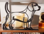 Side profile of a large Beagle line art sculpture on a wooden shelf with glowing pillar candles and a colorful bookshelf below — modern oversized 3D printed beagle home decor, minimalist hound silhouette, and a personal beagle gift for dog moms, beagle owners, and dog lovers.