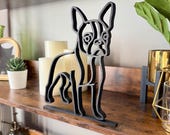 Boston Terrier line art sculpture styled with modern shelf decor including candles and plants. A sleek and lightweight dog figure for contemporary home accents and Boston Terrier owners.