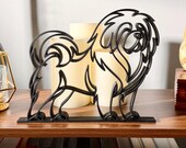 Minimalist Close-up of a Tibetan Mastiff sculpture on a wooden shelf styled with candles and a potted plant, showcasing its curved outline in matte black line art.