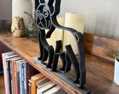 Close side view of a French Bulldog line art figure with upright ears. Matte black finish, designed as contemporary shelf and desk decor for dog lovers.