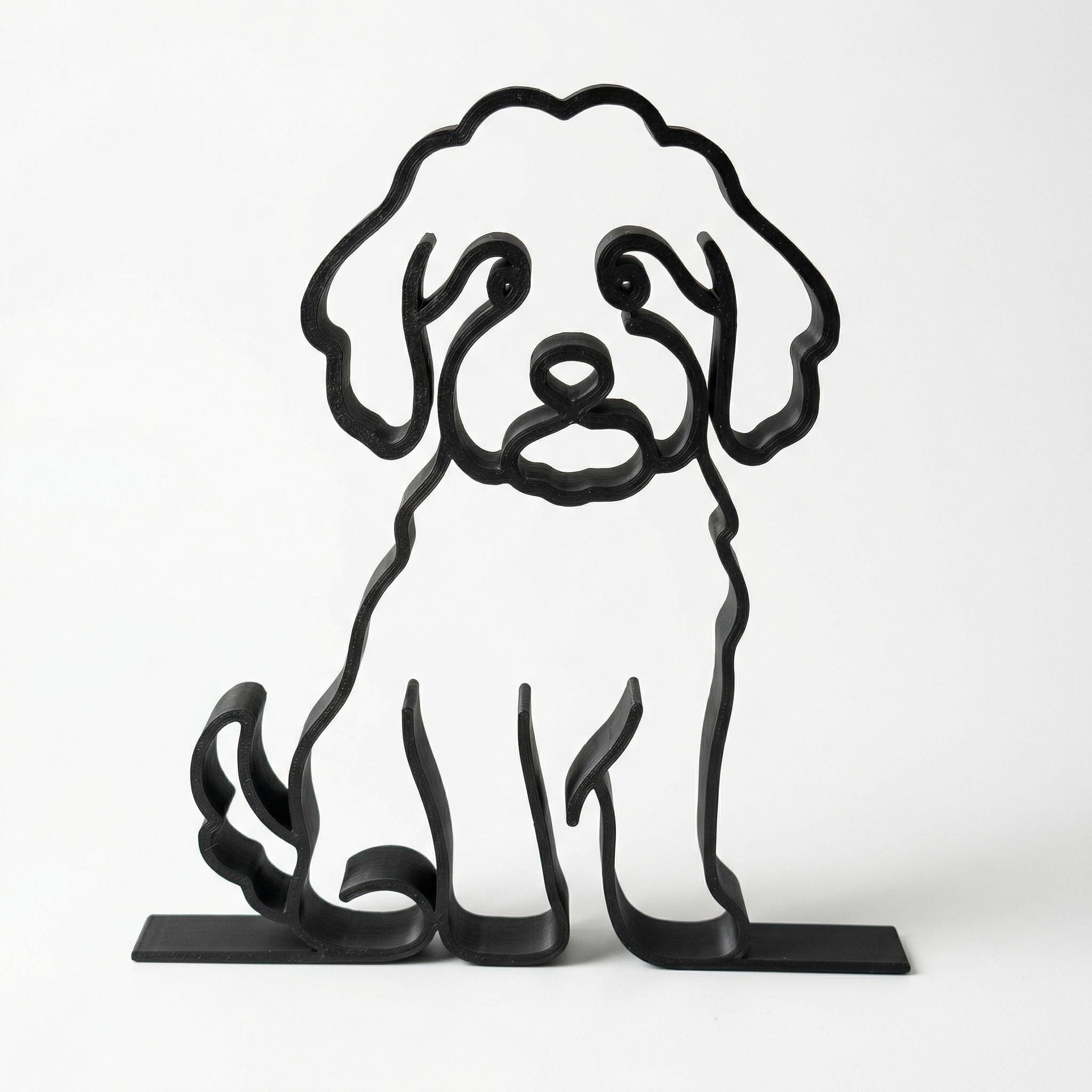 Matte black Mini Goldendoodle line art sculpture displayed on a modern bookshelf