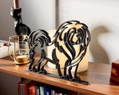 Angled view of the Tibetan Mastif sculpture highlighting its dimensional 3D lines and modern minimalist design, styled with candles and home accessories.