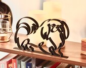 Pekingese dog line art statue in matte black on styled bookshelf with cookbooks and candles, thoughtful gift idea for Pekingese owners