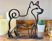 Close-up of a Shiba Inu line art dog sculpture in matte black, minimalist Japanese dog breed statue for shelves, mantels, or desks.