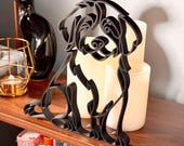 Detail view of a Bernedoodle line art sculpture highlighting the breed's curly doodle coat, sweet face, and continuous-line silhouette, backlit by warm candlelight on a wooden shelf — modern 3D printed Bernedoodle home decor and a heartfelt Bernedoodle gift for dog moms, dog dads, and doodle families.