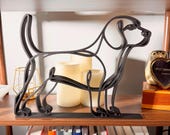 Large Beagle line art sculpture in standing profile displayed on a wooden shelf with warm glowing candles, a vintage clock, and colorful books below — oversized 3D printed beagle decor and a statement-size beagle gift for beagle owners, hound lovers, and dog moms who love minimalist home decor.