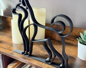 Husky shelf sitter in minimalist line art, sleek modern dog sculpture with curled tail and pointed ears