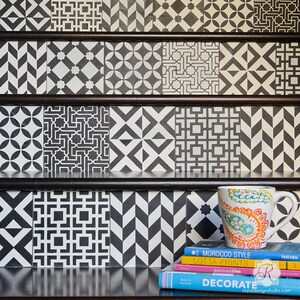 May include: Black and white geometric patterned stair treads with a black and white patterned mug and a stack of books on the bottom step. The books have titles like "Morocco Style", "Lotta Prints", "Mexican Tiles", and "Decorate".