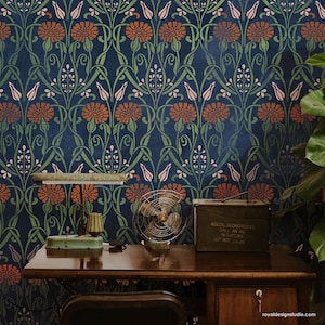 May include: A dark blue wallpaper with a repeating pattern of stylized flowers and leaves. The wallpaper is decorated with orange, pink, and green colors. A desk with a lamp, a fan, and a metal box with the text "400 CAL.30 CARTRIDGES  FILL AN ME  INCH. ROUND  LOT NO. 6745" is in front of the wallpaper.