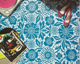 May include: A white background with a blue lace pattern. The lace pattern features a repeating floral design. Two pink high-heeled shoes are on the right side of the image.