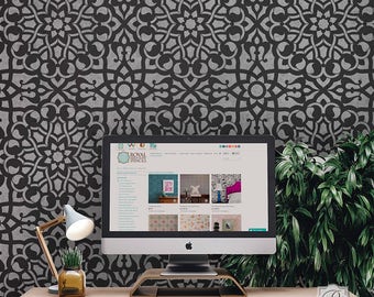 May include: A black and white geometric stencil pattern on a wall, with a computer monitor displaying a website for Royal Stencils. The website shows various stencil designs and examples of how they can be used.