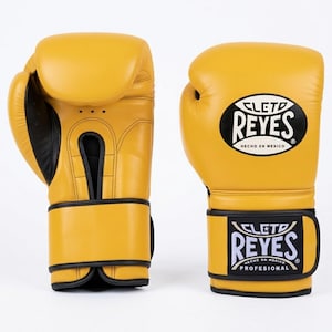 A Pair of Yellow Cleto Reyes leather boxing gloves featuring a hook-and-loop closure, black inner thumb, and iconic branding.