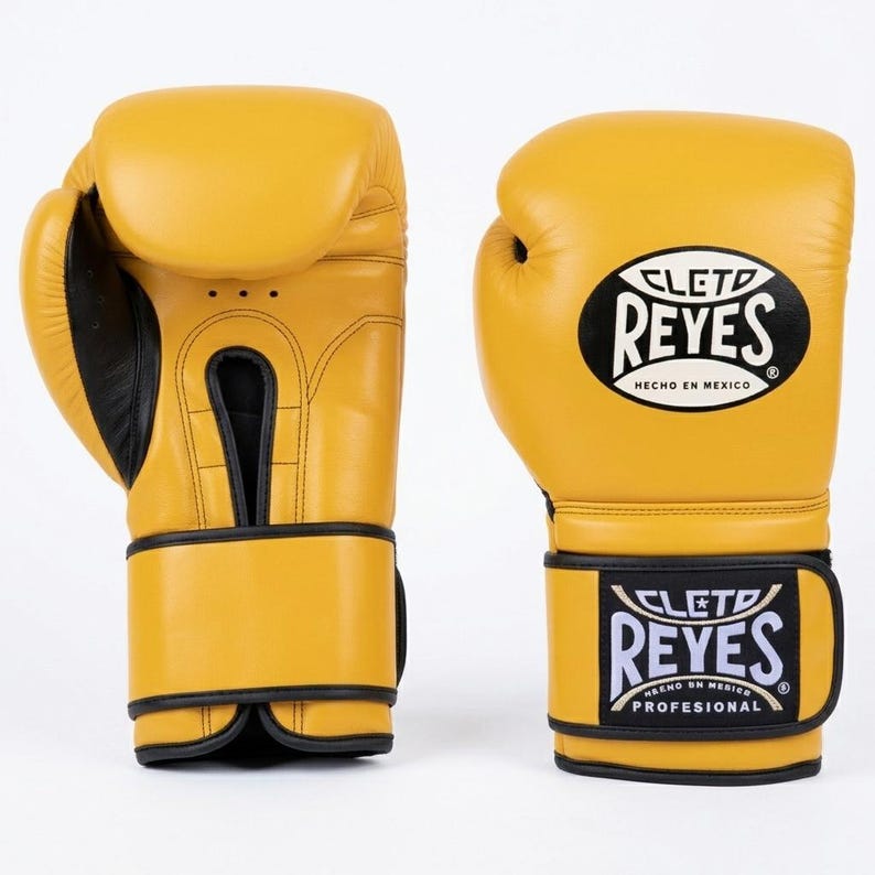 A Pair of Yellow Cleto Reyes leather boxing gloves featuring a hook-and-loop closure, black inner thumb, and iconic branding.