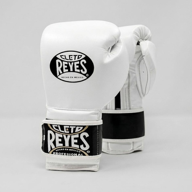 White Cleto Reyes professional boxing gloves featuring a hook-and-loop closure, white inner thumb, and iconic branding.
