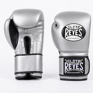 A pair of silver Cleto Reyes leather boxing gloves featuring a hook-and-loop closure, black inner thumb, and iconic branding.
