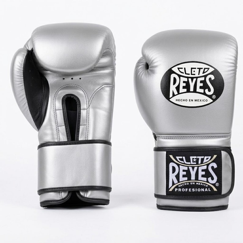 A pair of silver Cleto Reyes leather boxing gloves featuring a hook-and-loop closure, black inner thumb, and iconic branding.