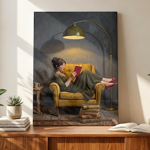 May include: A vertical wall art print depicting a person in a dark green dress sitting in a yellow armchair, reading a red book under a gold floor lamp. A stack of books sits on the floor beside the chair, and a small side table is nearby.